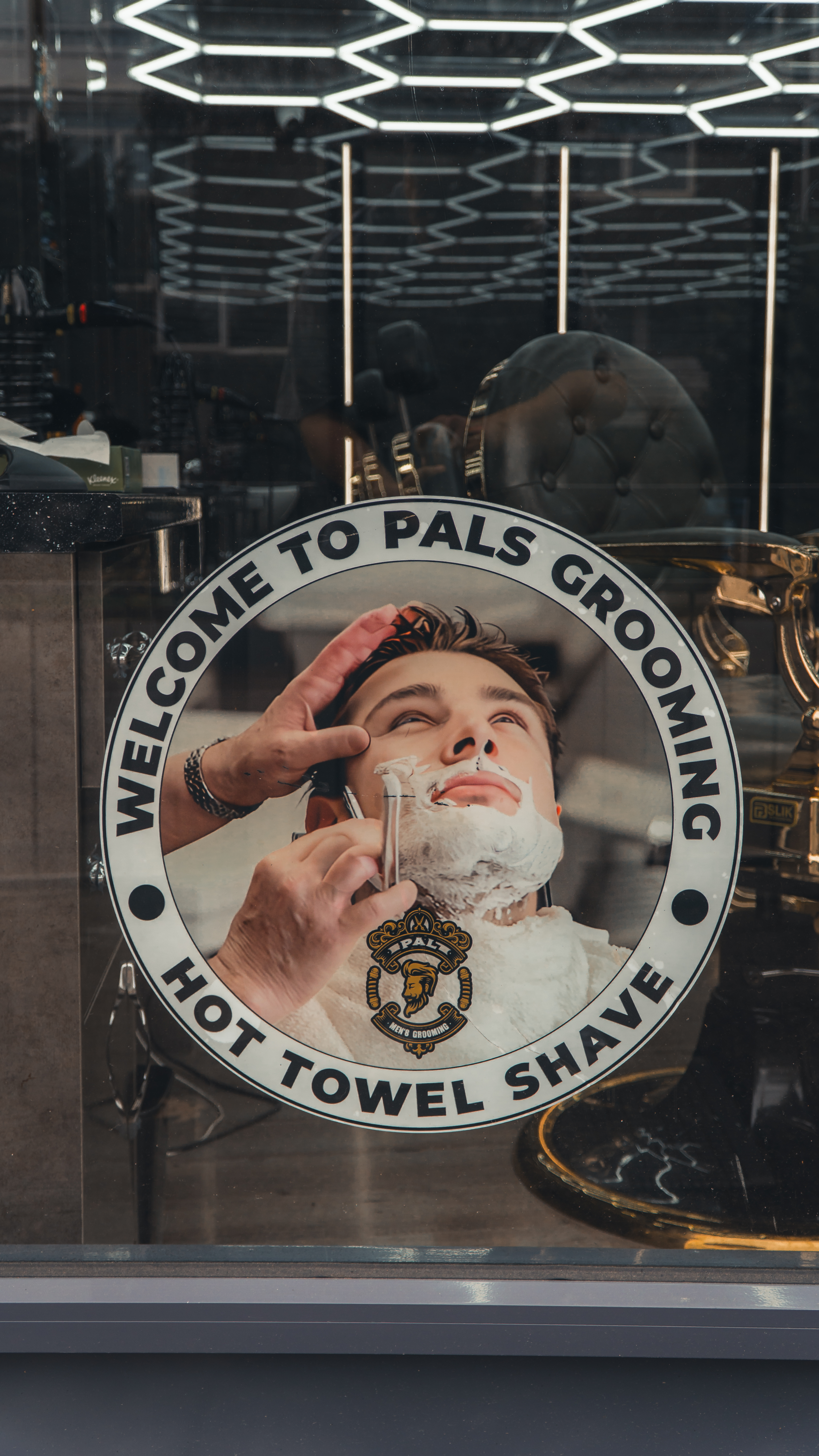 Barber shaping a beard line with a razor